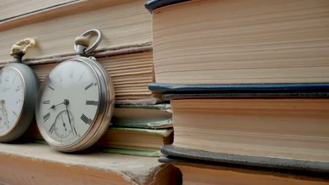 Set of three silver antique pocket watch with against background of stacks of Video stock 203292652