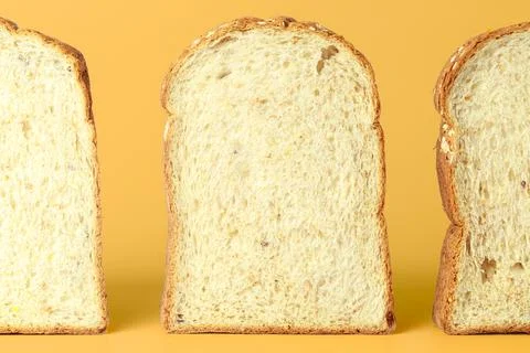 Set of three slices of bread slices isolated on yellow background. Stock Photos
