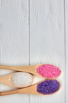 Set of three spoons with colored crystal salt and copy space. Stock Photos
