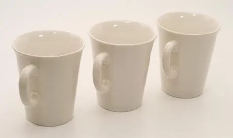 Set of three white mugs Stock Photos