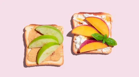 Set of toasted bread with peach and apple on pink background Stock Photos