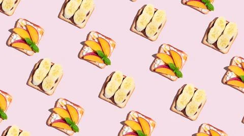 Set of toasted bread with peach and banana on pink background. Pattern Stock Photos