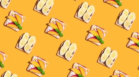 Set of toasted bread with peach and banana on yellow background. Pattern Stock Photos