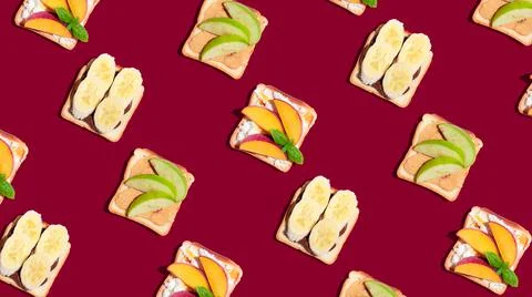 Set of toasted bread with peach, apple and banana on red background. Pattern Stock Photos