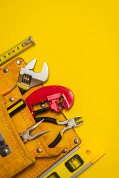 Set of tool in suede bag on yellow background prepared by the plumber master Stock Photos