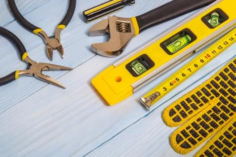 Set of tools and work gloves on blue boards prepared by the master Stock Photos