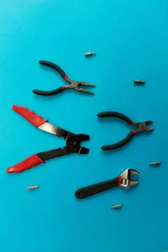 Set of tools on blue background. It looks like a shoal of fish. Working handm Stock Photos