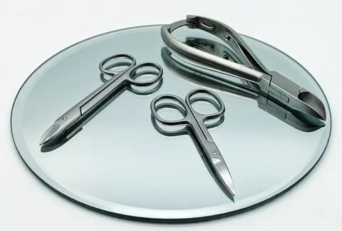 Set of tools to cut nails on reflective display. Stock Photos