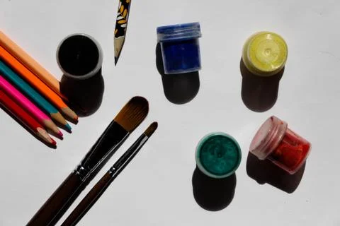 A set of tools for drawing - paint, brushes, colored pencils. Stock Photos