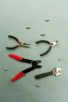 Set of tools on grey background. It looks like a shoal of fish. Working handm Stock Photos