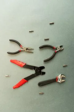 Set of tools on grey background. It looks like a shoal of fish. Working handm Stock Photos