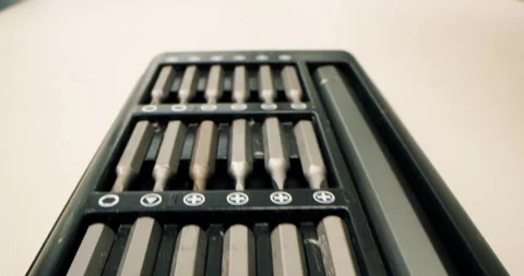 Set of tools for home use and professionals. Screwdriver bit set box on purple Stock Footage 309917545