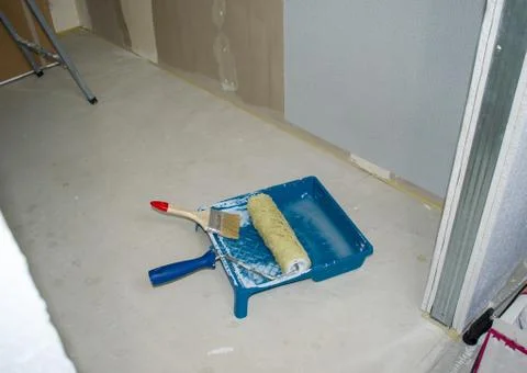 Set of tools for the painter and redecoration on the floor. Stock Photos