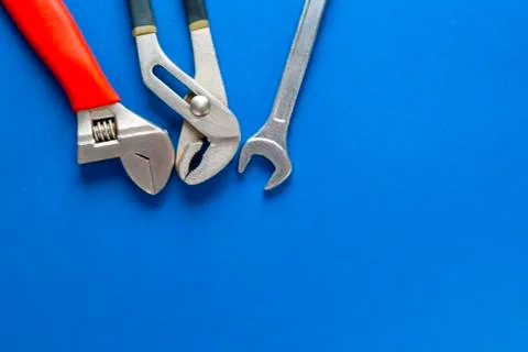 A set of tools for plumbing, isolated on a blue background. Stock Photos