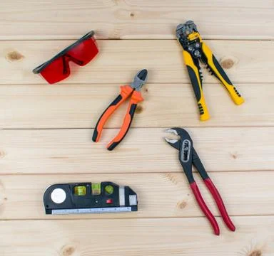 Set of tools for repai and carpentry. Red protective glasses, flat-nose plier Stock Photos