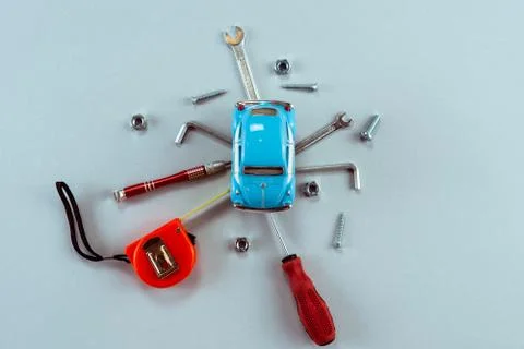 Set of tools wrenches with blue toy car in the centre. Car  service concept.  Stock Photos