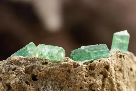 Set of Tourmaline Crystals on Rough Stone Background Stock Photos