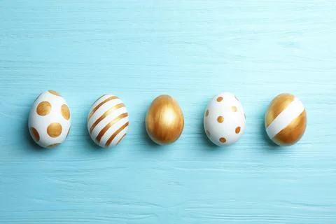 Set of traditional Easter eggs decorated with golden paint on wooden backgrou Stock Photos
