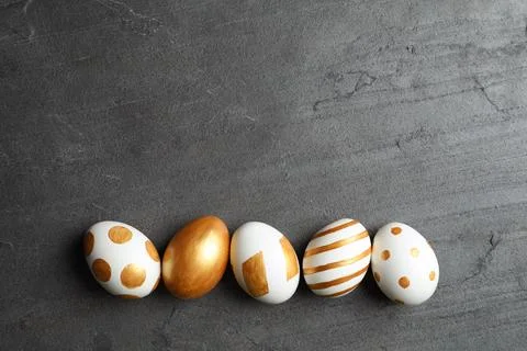Set of traditional Easter eggs decorated with golden paint on grey background 스톡 사진