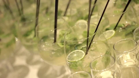 Set of transparent glasses on high legs with reflections filled with mojito Vídeo Stock 75231246
