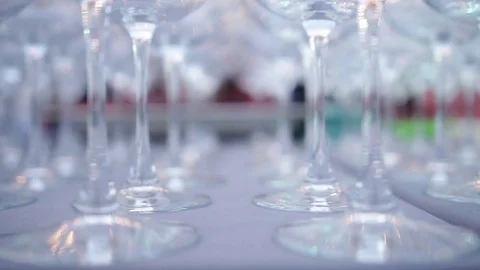 A set of transparent wine glasses on high legs, close-up. Slow motion Stock-Footage 72603205