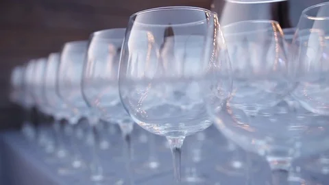 A set of transparent wine glasses on high legs, close-up. Slow motion Stock-Footage 72603209