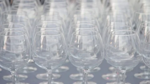 A set of transparent wine glasses on high legs, close-up. Slow motion Stock-Footage 72603210