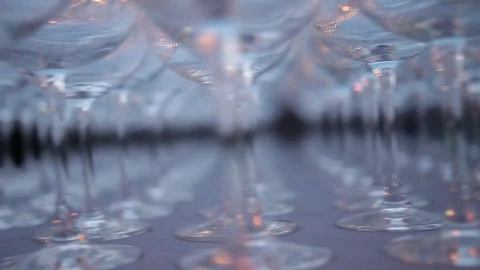 A set of transparent wine glasses on high legs, close-up. Slow motion Stock Footage 72603225