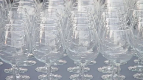 A set of transparent wine glasses on high legs, close-up. Slow motion Stock-Footage 72603247