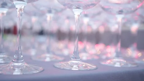 A set of transparent wine glasses on high legs, close-up. Slow motion Vídeo Stock 73668719