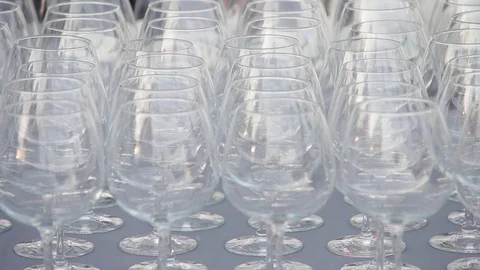 A set of transparent wine glasses on high legs, close-up. Slow motion Stock-Footage 73668729