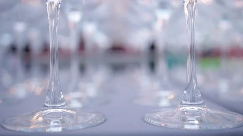 A set of transparent wine glasses on high legs, close-up. Slow motion Stock-Footage 73668808