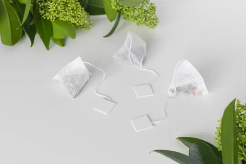 Set of triangle infusion tea bag with tag on white background. Space for text Stock Photos