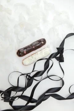 Set of two eclairs with a decor of black and white chocolate isolate on a whi Stock Photos