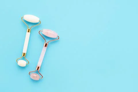 Set of two massage rollers for face on light blue background. Selfcare, skincare Stock Photos