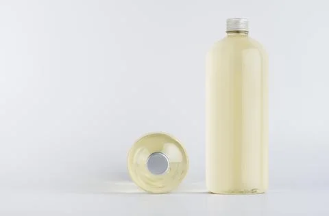 Set of two transparent plastic tall bottles standing and lying with pale fres Stock Photos