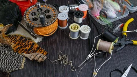 A set of various accessories and materials for tying flies for fly fishing. C Stock Photos