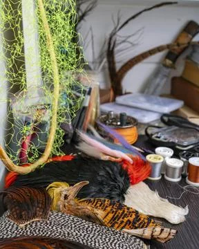 A set of various accessories and materials for tying flies for fly fishing. C Stock Photos