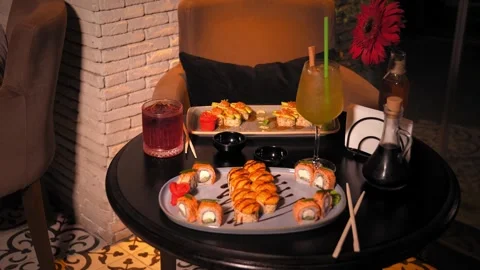 Set of various delicious appetizing sushi rolls on table with cocktail, Stock Footage 269560948