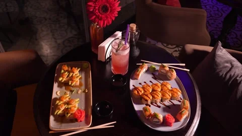 Set of various delicious appetizing sushi rolls on table with cocktail, Видео 269562305