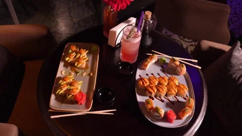 Set of various delicious appetizing sushi rolls on table with cocktail, Vidéo 269566034