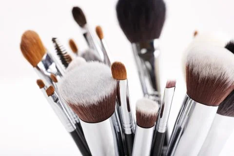 Set of various makeup brushes on white background. Stock Photos