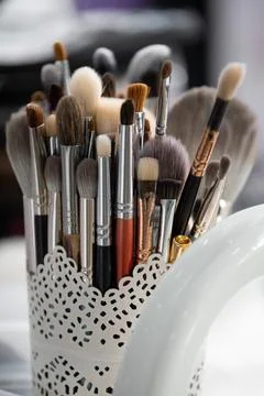 Set of various professional makeup brushes on makeup artist's desk Stock Photos