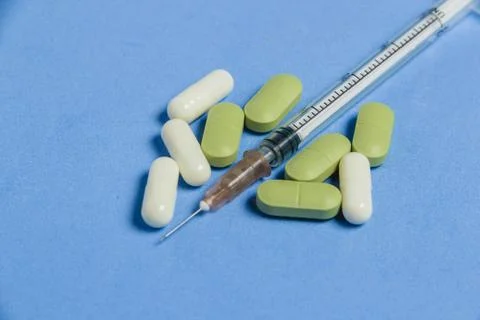 Set of Various Tablets, Capsules, Syringe on Blue Background. Medicine Concept. Stock Photos