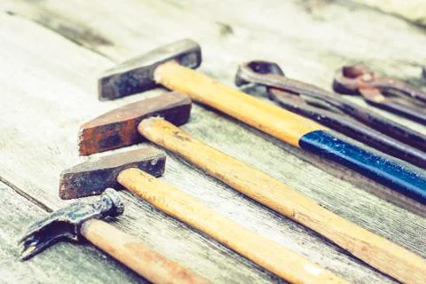 Set of vintage hand construction tools hammers on a wooden background, retro Stock Photos