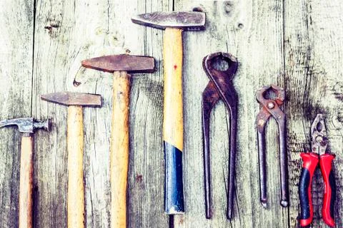 Set of vintage hand construction tools hammers on a wooden background, retro Stock Photos