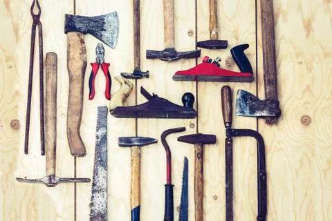 Set of vintage hand construction tools hammers on a wooden background, retro Stock Photos