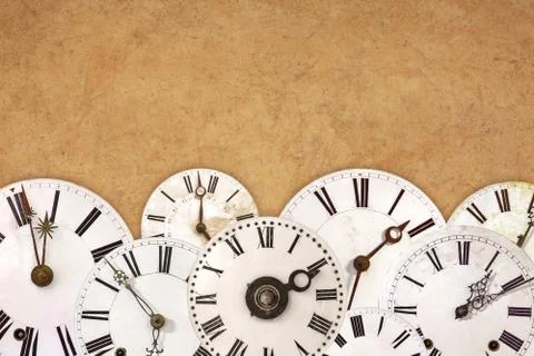 Set of vintage white clock faces against an old brown background Stock Illustration
