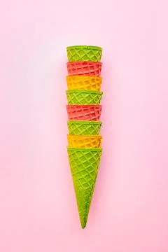 Set of waffle multicolored empty ice cream cones on a pink background. Stock Photos