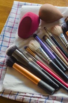 Set of washed and cleaned make up brushes and two make up sponges Stock Photos